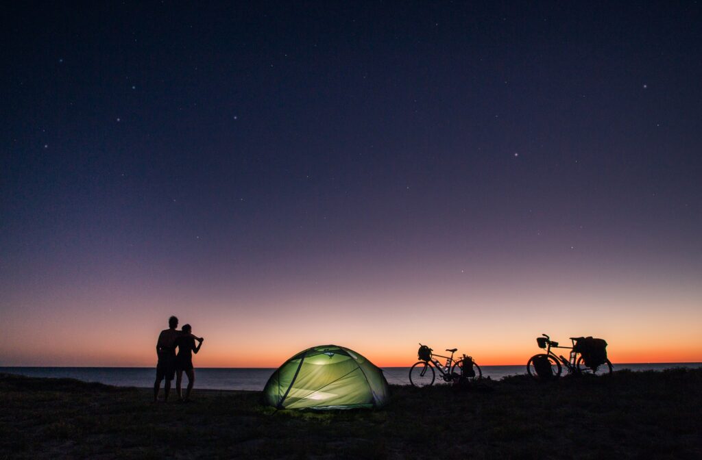 Couple with tent and bicycle on nature