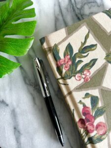Journal and pen with monstera leaf
