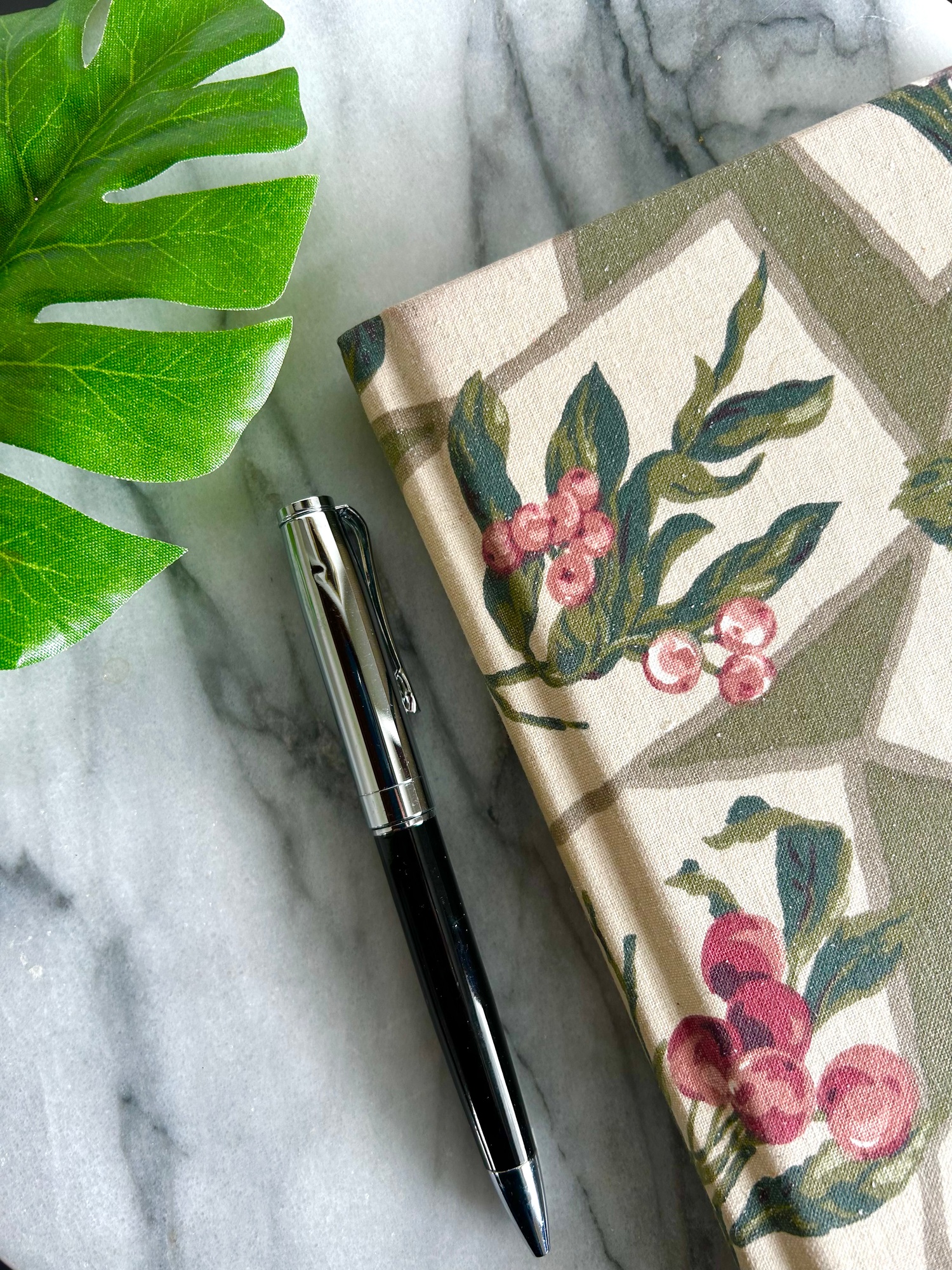 Journal and pen with monstera leaf
